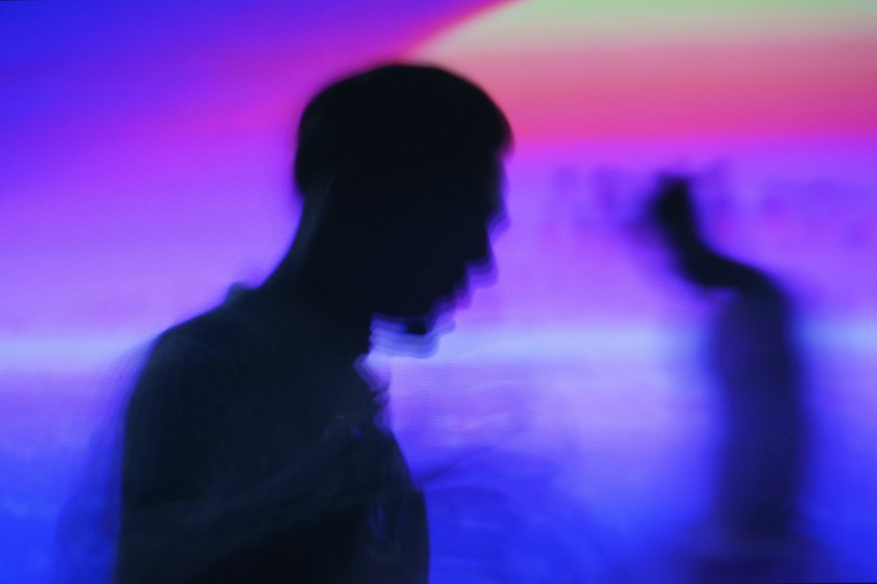 Vibrant abstract silhouette with blue and purple motion blur creating ethereal effect.
